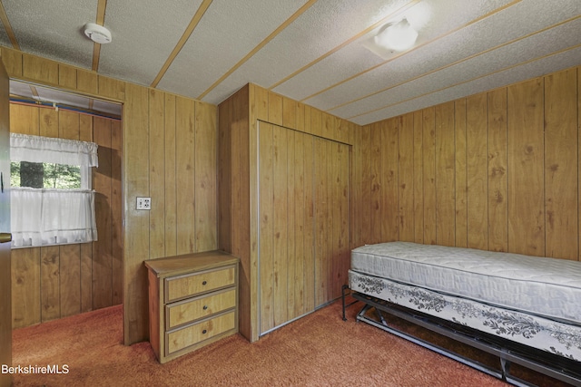 159 Black Brook Rd, Savoy, MA 01256 - carpeted bedroom with wooden walls and a textured ceiling