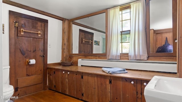 bathroom with hardwood / wood-style flooring and toilet