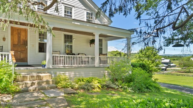 property entrance with covered porch