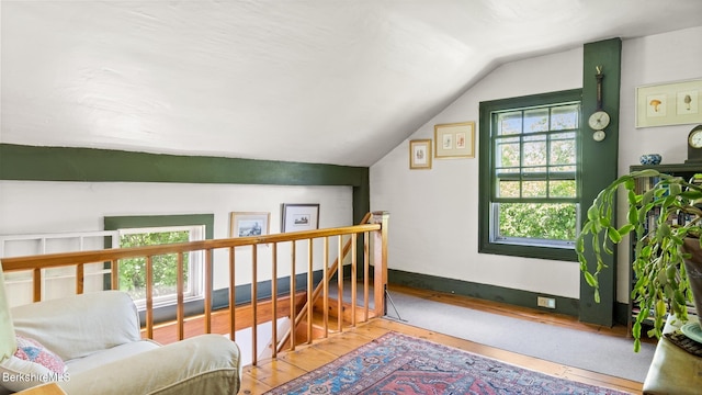 bonus room with hardwood / wood-style floors and lofted ceiling