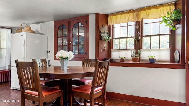 dining space with an AC wall unit