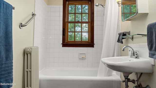 bathroom featuring shower / bathtub combination with curtain and radiator heating unit