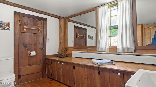 bathroom featuring hardwood / wood-style flooring and toilet