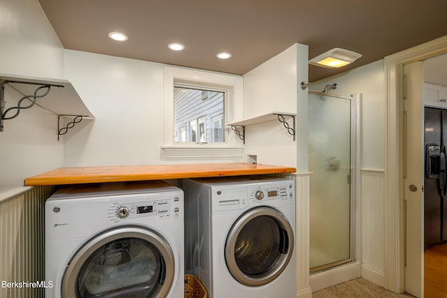 washroom with washing machine and clothes dryer