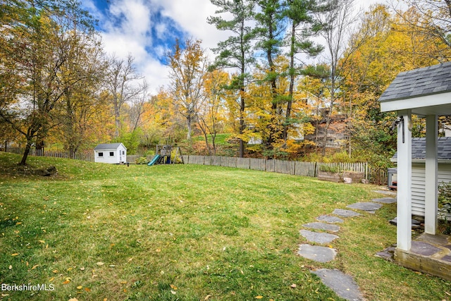 view of yard featuring a playground and a storage shed