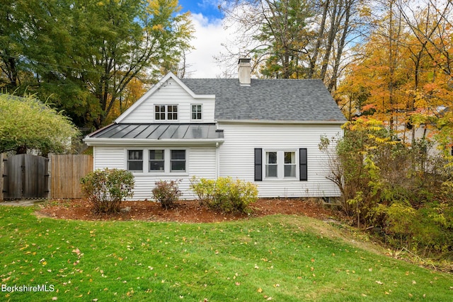 rear view of property with a yard