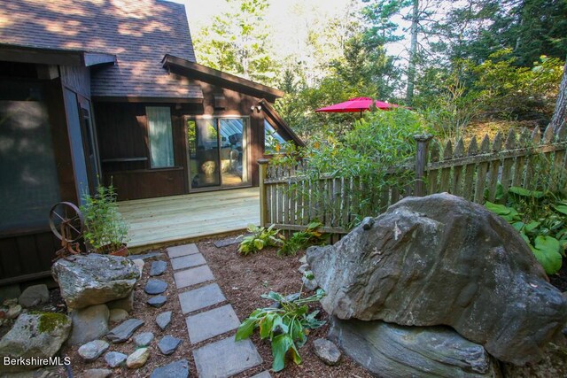 view of yard with fence and a wooden deck