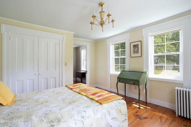 311 N Plain Rd, Great Barrington, MA 01236 - bedroom with radiator heating unit, a chandelier, baseboards, wood-type flooring, and ornamental molding