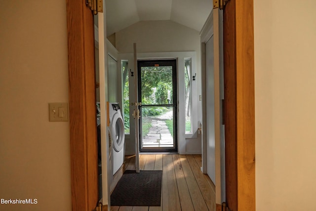 doorway with dark hardwood / wood-style floors and lofted ceiling