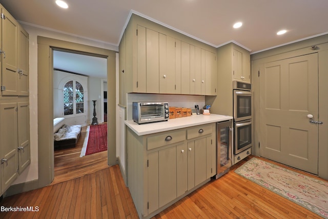 49 Main St, Stockbridge, MA 01262 - kitchen with light wood-type flooring, stainless steel double oven, light countertops, beverage cooler, and recessed lighting