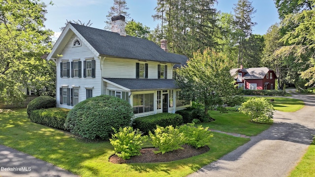 49 Main St, Stockbridge, MA 01262 - view of front of house with a chimney, roof with shingles, and a front lawn