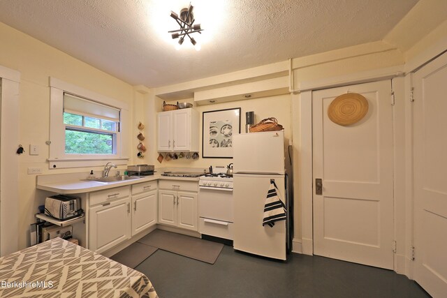 49 Main St, Stockbridge, MA 01262 - kitchen with white appliances, white cabinets, light countertops, and a textured ceiling