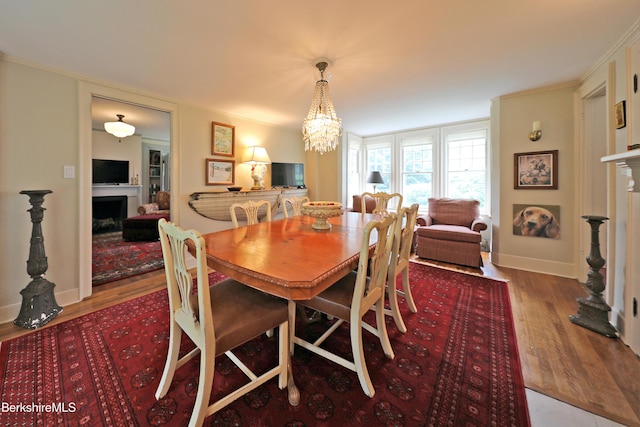 49 Main St, Stockbridge, MA 01262 - dining room with a fireplace, wood finished floors, a chandelier, and ornamental molding