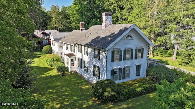 49 Main St, Stockbridge, MA 01262 - view of front of home with a chimney, a front yard, and a view of trees