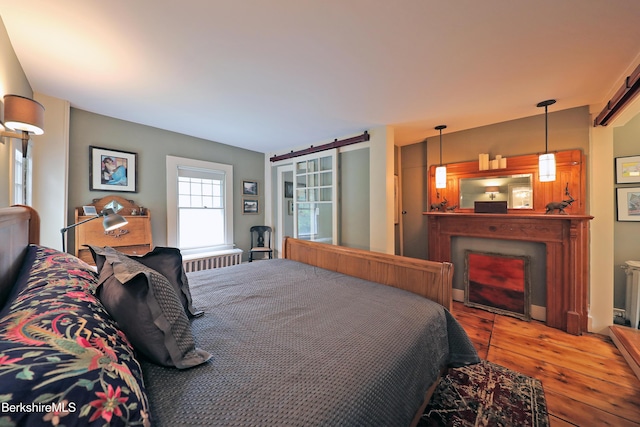 49 Main St, Stockbridge, MA 01262 - bedroom with hardwood / wood-style flooring and a fireplace
