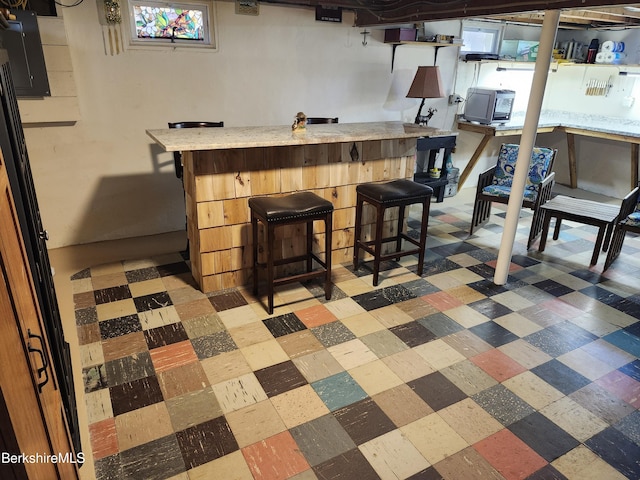 bar featuring light floors and a bar