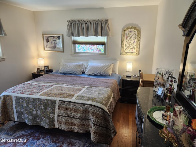 bedroom with hardwood / wood-style flooring