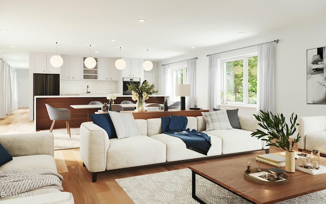 living room featuring light wood-type flooring and sink