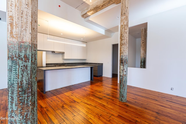 kitchen featuring white cabinets, dark hardwood / wood-style floors, and a center island