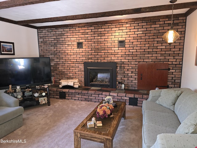 living room with carpet, beam ceiling, and a brick fireplace