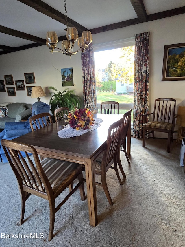 dining space with a chandelier, beamed ceiling, and carpet flooring