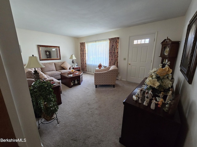 carpeted living room with a baseboard heating unit