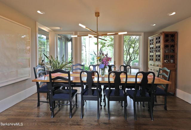 dining room featuring a chandelier, a healthy amount of sunlight, and dark hardwood / wood-style floors