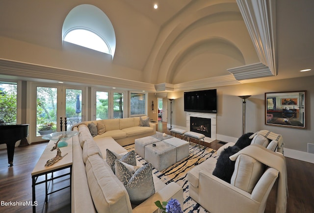 living room featuring a high end fireplace, french doors, and hardwood / wood-style flooring