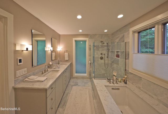 bathroom featuring separate shower and tub and vanity