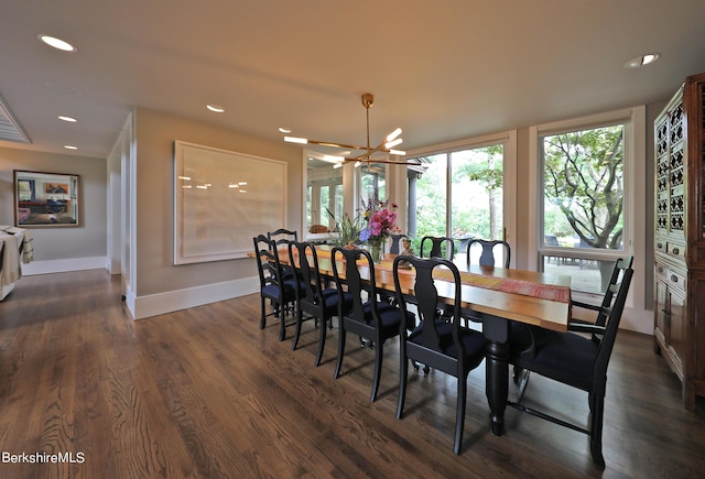 dining space with dark wood-type flooring and a notable chandelier