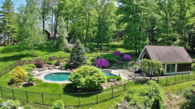 view of pool with a lawn and a patio