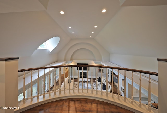 stairs featuring vaulted ceiling with skylight