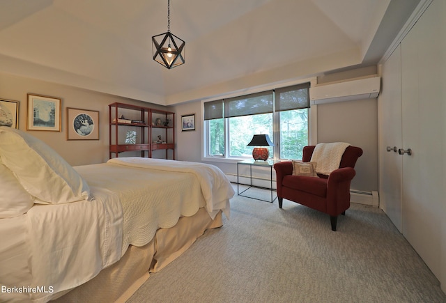 bedroom featuring an AC wall unit, light carpet, and a baseboard heating unit