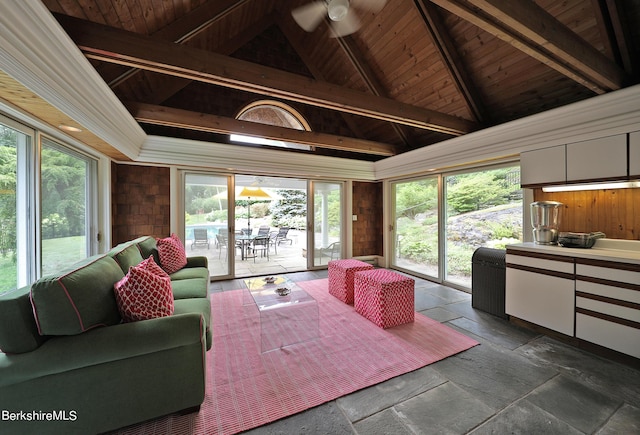 sunroom / solarium with vaulted ceiling with beams, ceiling fan, and wooden ceiling