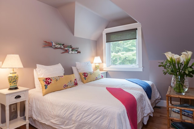 bedroom featuring hardwood / wood-style floors and lofted ceiling