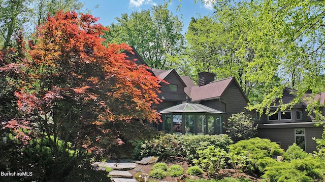 view of side of property featuring a sunroom