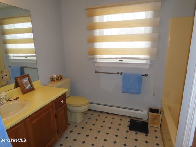 full bath with toilet, vanity, and baseboard heating