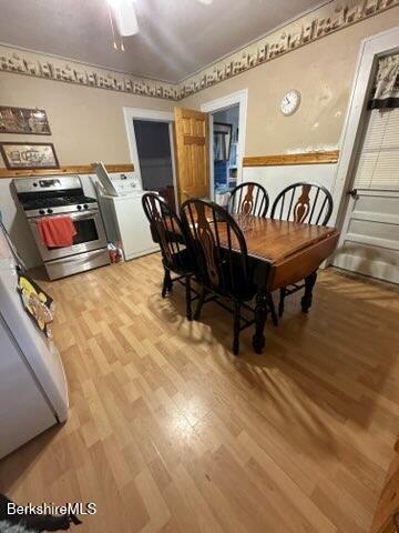 dining space with light hardwood / wood-style flooring and washer / dryer