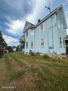 view of side of home featuring a yard