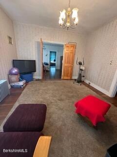 living room featuring dark wood-type flooring and a chandelier