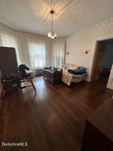 interior space featuring dark hardwood / wood-style floors and a notable chandelier