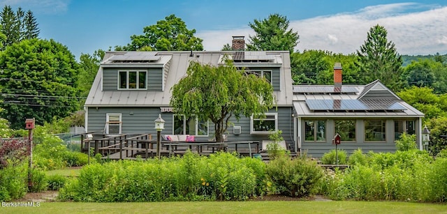 back of property featuring solar panels