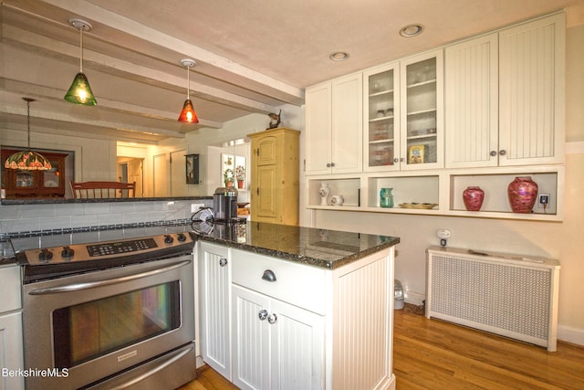 kitchen with radiator, stainless steel range, pendant lighting, beamed ceiling, and white cabinetry