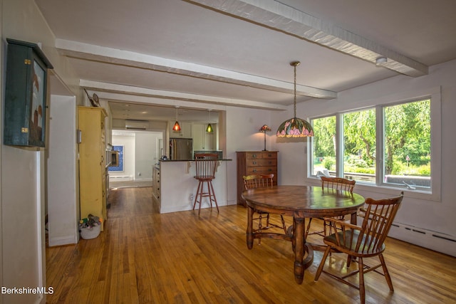 dining space with a wall mounted air conditioner, wood-type flooring, and beamed ceiling