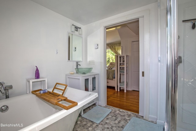 bathroom featuring plus walk in shower and vanity