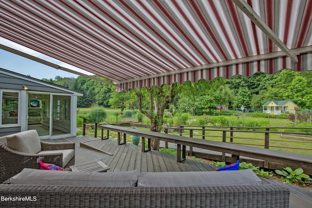 wooden terrace featuring outdoor lounge area