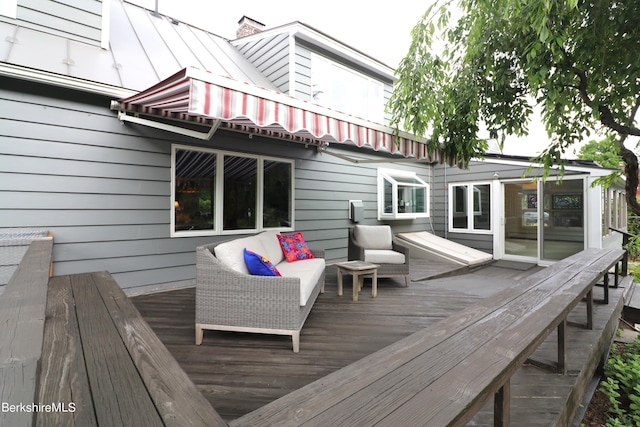 wooden terrace with an outdoor hangout area