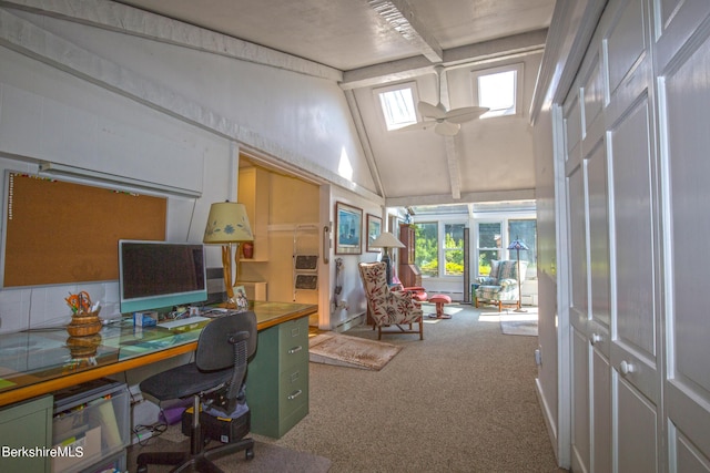 carpeted office space featuring high vaulted ceiling and a skylight