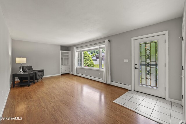 83 Bradley St, North Adams, MA 01247 - foyer featuring a baseboard radiator and wood finished floors