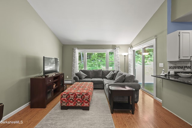 83 Bradley St, North Adams, MA 01247 - living area featuring lofted ceiling, light wood-style flooring, and baseboard heating